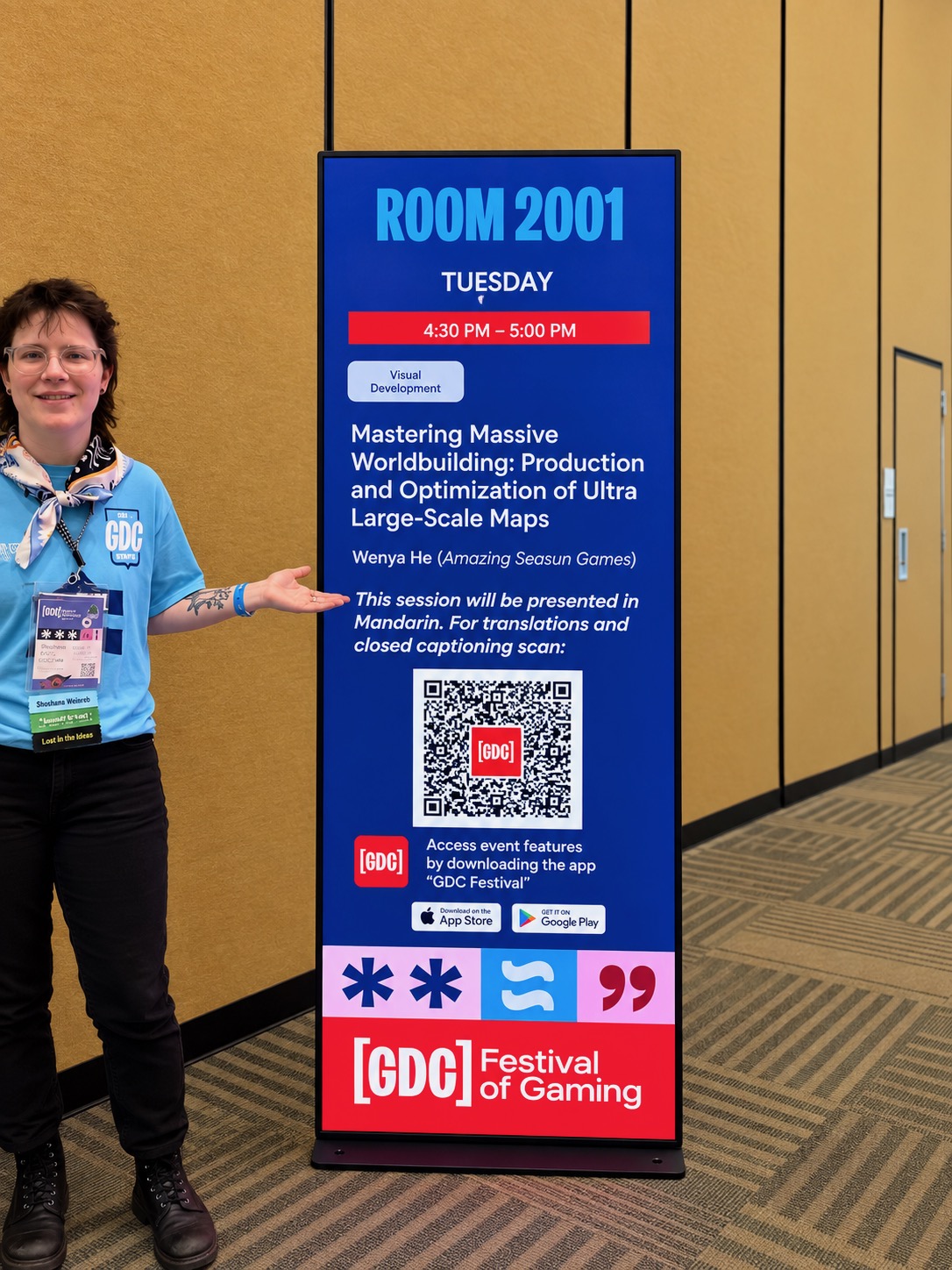 GDC staff beside Room 2001 signage directing attendees to translation and closed-caption access